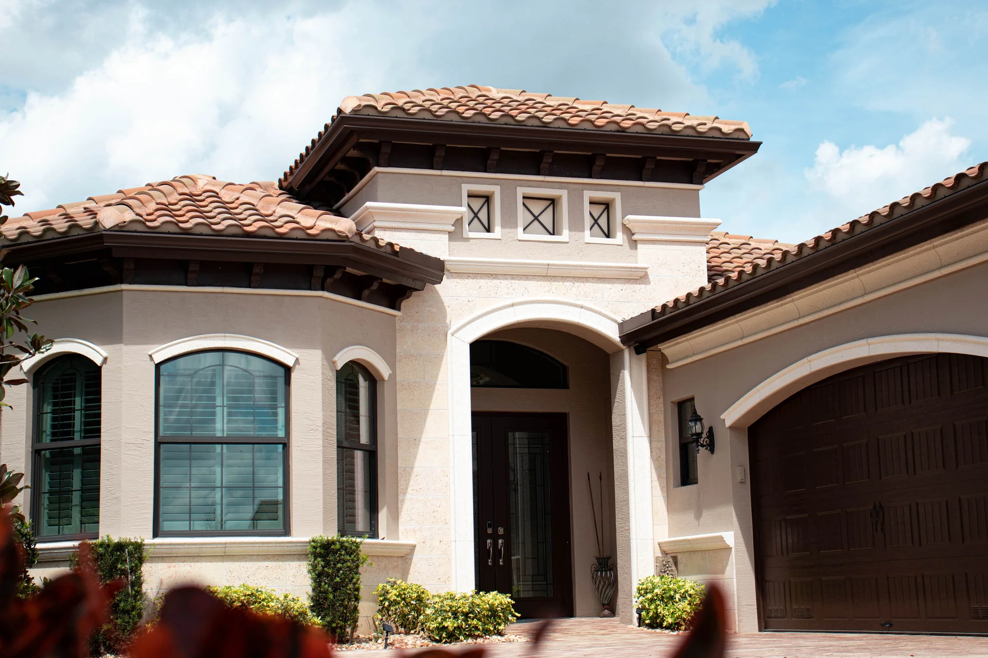 Exterior paint color swatches including warm whites, sage greens, and coastal blues tested on Florida stucco in direct sunlight