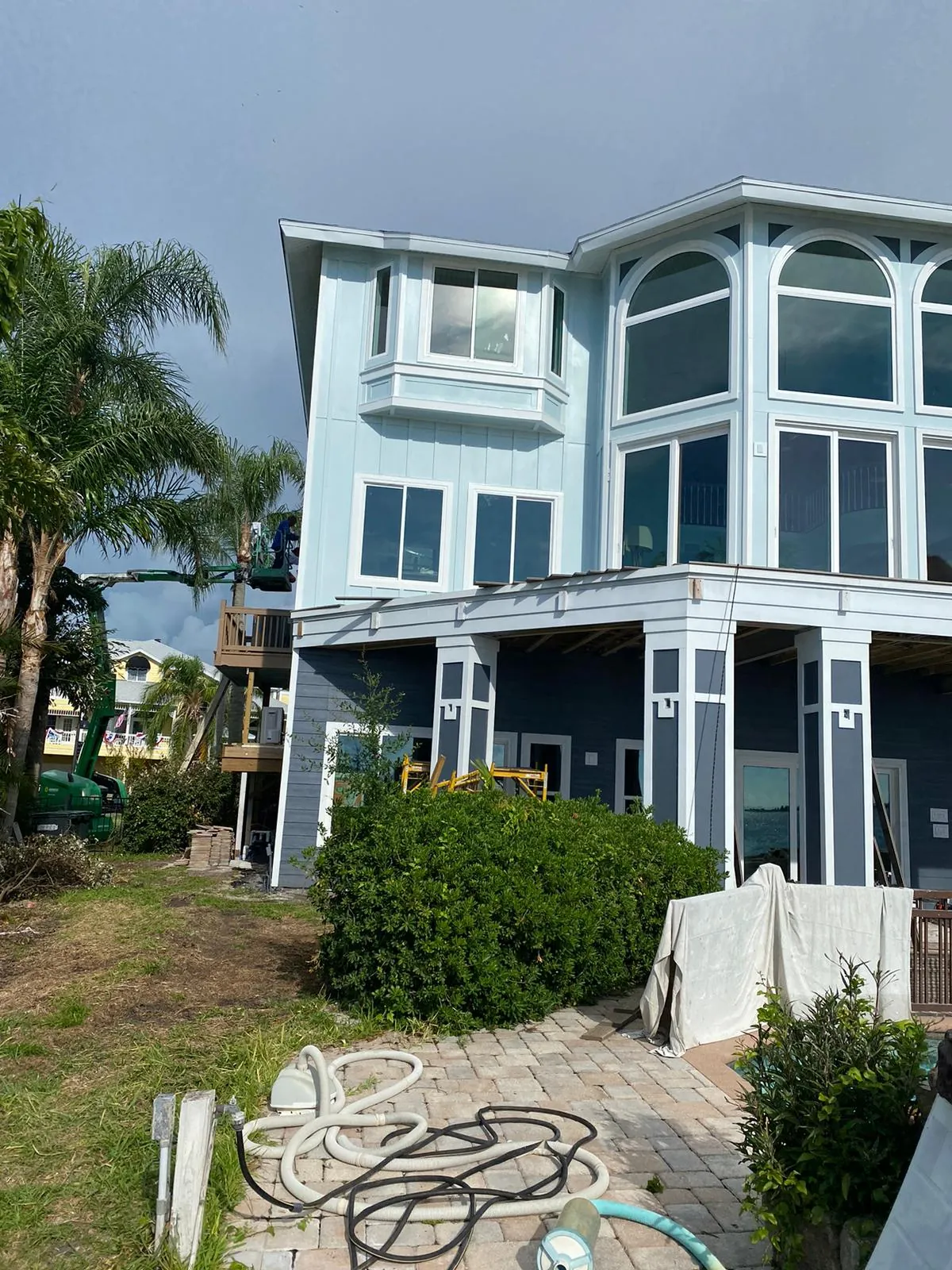 Complete exterior repaint of multi-story waterfront home by Westchase Painting Company